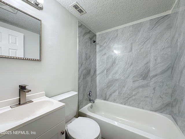 full bathroom with vanity, tiled shower / bath, a textured ceiling, and toilet