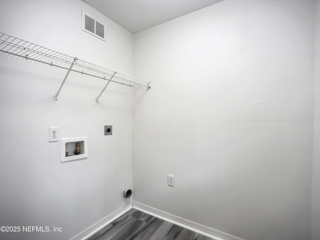 washroom with dark hardwood / wood-style floors, washer hookup, and hookup for an electric dryer