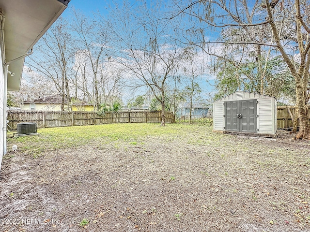 view of yard with cooling unit and a storage shed