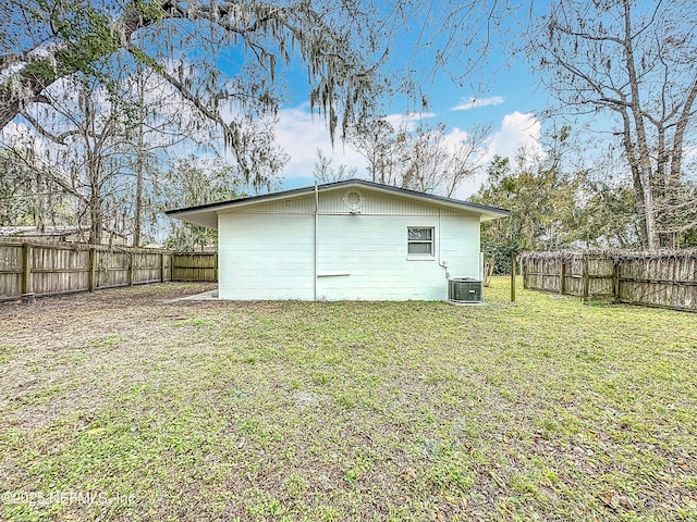 back of house with a yard and central AC unit