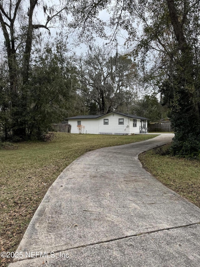 view of side of property with a lawn