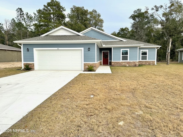 view of front of property with a front lawn and a garage