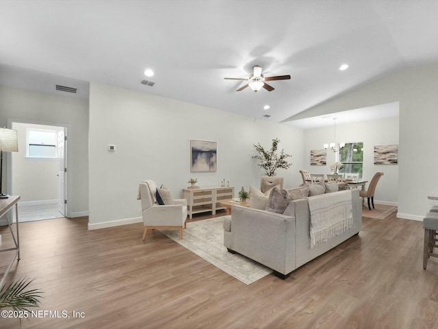 living room with vaulted ceiling, light hardwood / wood-style floors, and plenty of natural light