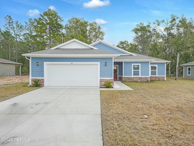 view of front of property with a front lawn and a garage