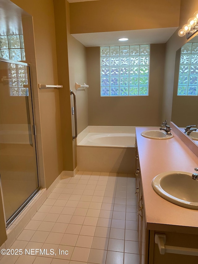 bathroom with independent shower and bath, tile patterned flooring, and vanity