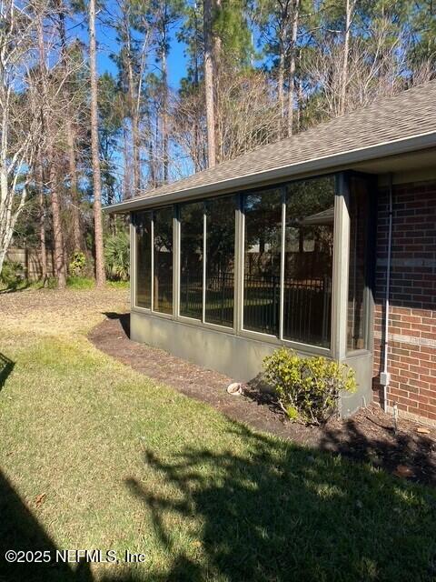 view of yard featuring a sunroom