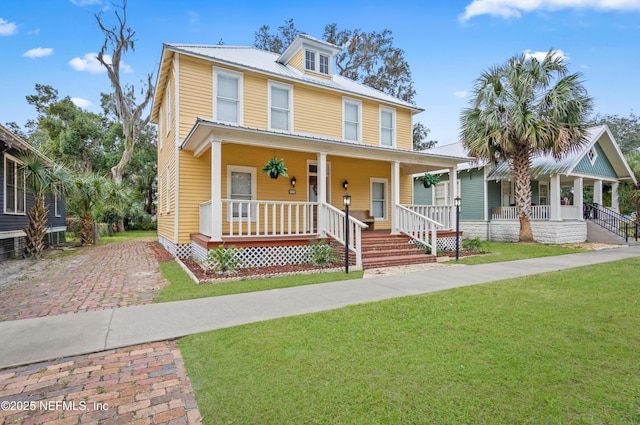 view of front of property with a front yard and covered porch