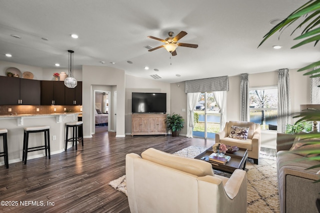 living room with lofted ceiling, dark hardwood / wood-style floors, and ceiling fan