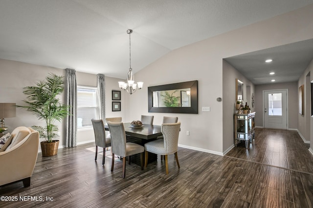 dining room with vaulted ceiling, dark wood-type flooring, and a notable chandelier