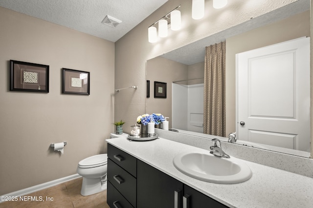 bathroom featuring vanity, walk in shower, toilet, tile patterned floors, and a textured ceiling