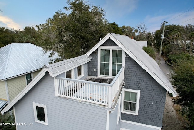 view of side of property with a balcony