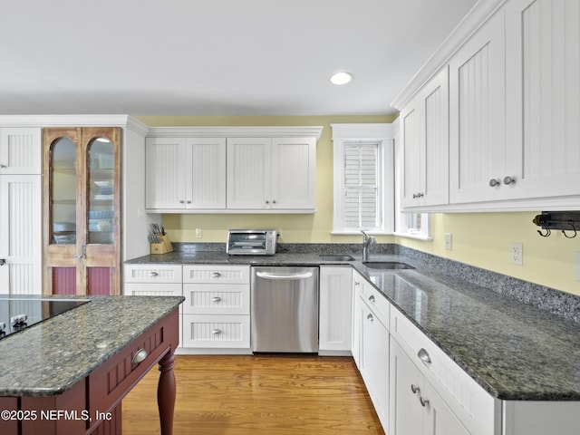 kitchen featuring white cabinets, stainless steel dishwasher, sink, and light wood-type flooring