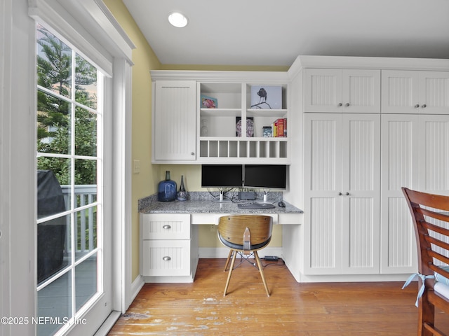 office featuring light wood-type flooring and built in desk