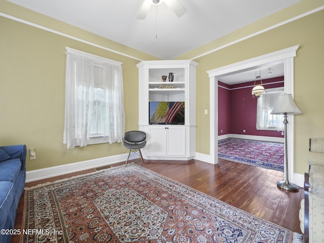 unfurnished living room with ceiling fan and dark hardwood / wood-style floors