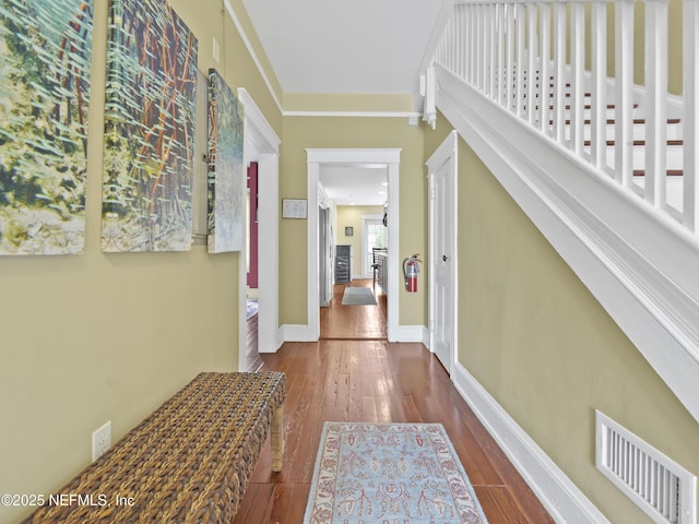 corridor with hardwood / wood-style floors