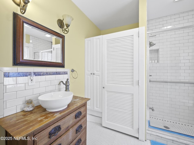 bathroom with an enclosed shower, vanity, tile walls, and tile patterned floors