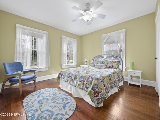 bedroom with ceiling fan and dark hardwood / wood-style flooring