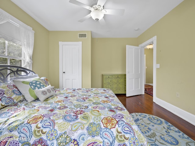 bedroom with ceiling fan and dark wood-type flooring