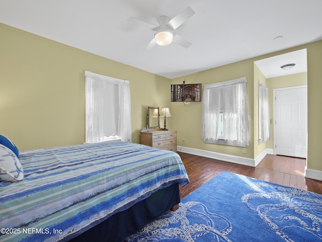 bedroom with ceiling fan and dark hardwood / wood-style floors