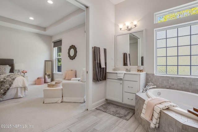 bathroom featuring vanity and a relaxing tiled tub