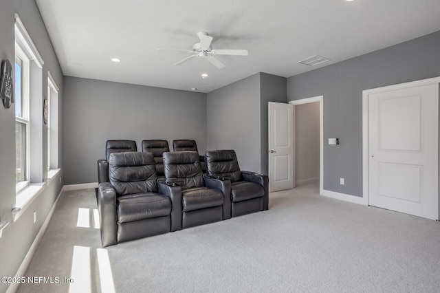 carpeted cinema featuring ceiling fan