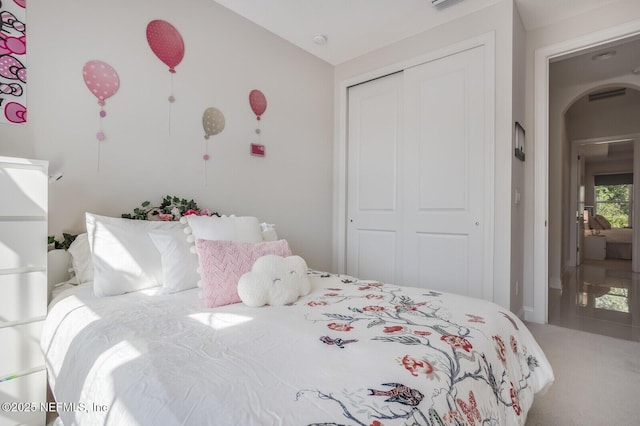 carpeted bedroom featuring a closet