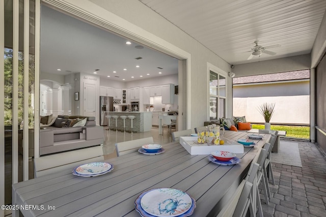 sunroom featuring ceiling fan