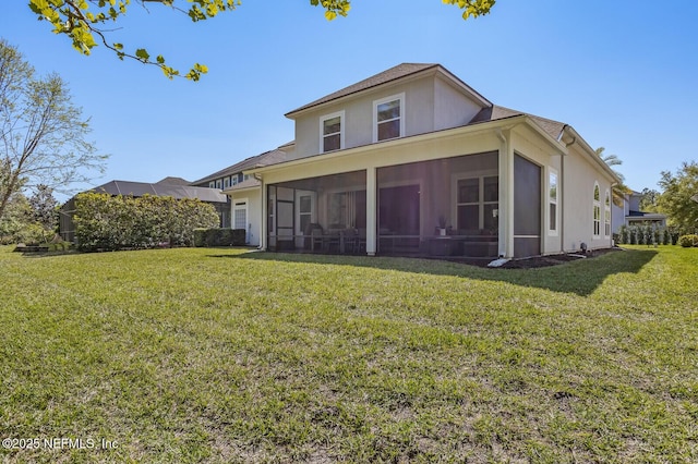 back of house with a sunroom and a lawn