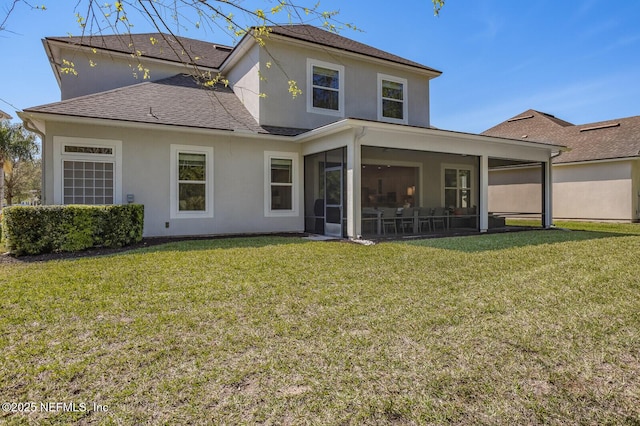 back of house with a yard and a sunroom