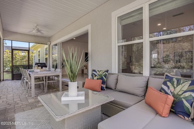 sunroom featuring ceiling fan