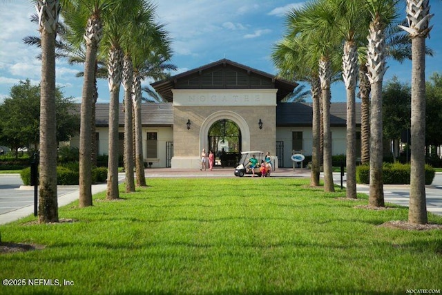 rear view of house featuring a lawn