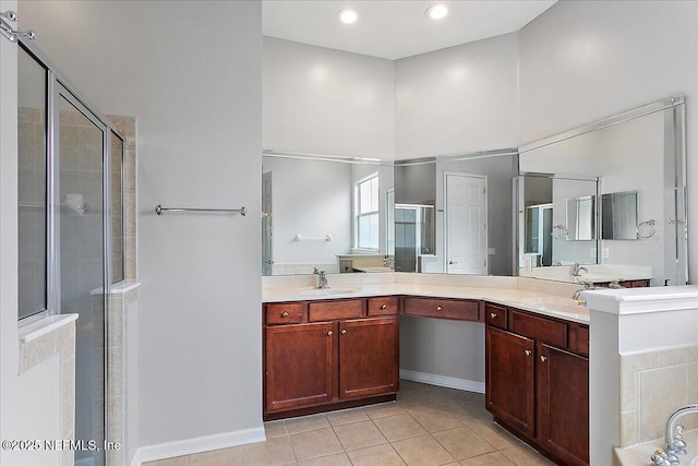 full bath featuring recessed lighting, a shower stall, vanity, and tile patterned floors