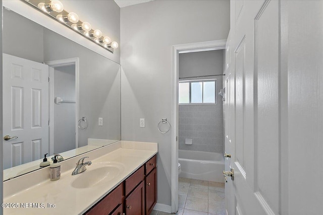 bathroom featuring toilet, tile patterned flooring, washtub / shower combination, and vanity