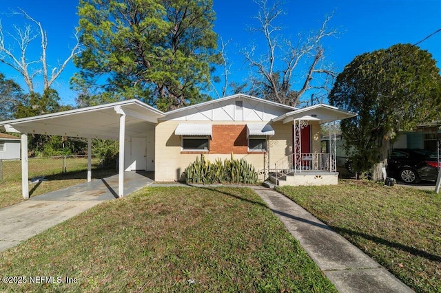 bungalow-style home featuring a front lawn and a carport