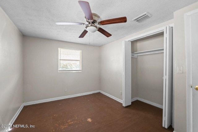 unfurnished bedroom with ceiling fan, a closet, and dark hardwood / wood-style flooring