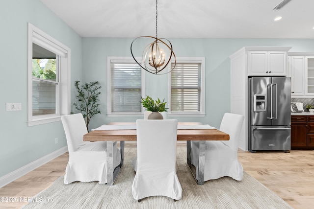 dining room featuring a chandelier and light hardwood / wood-style floors