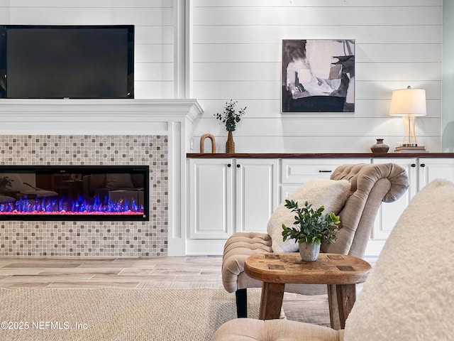 living room with a fireplace and light wood-type flooring