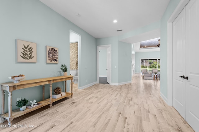 corridor featuring light hardwood / wood-style floors