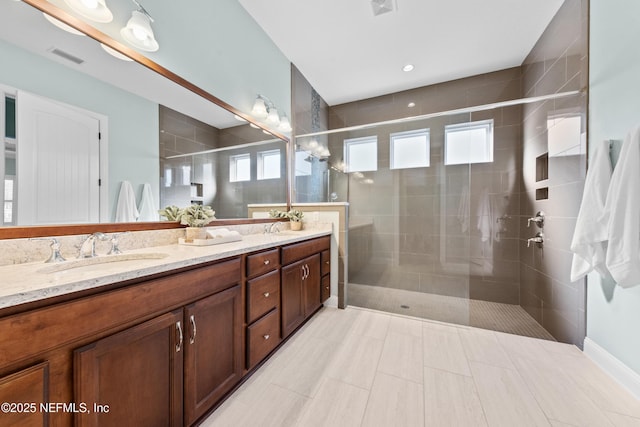 bathroom with vanity and a shower with shower door