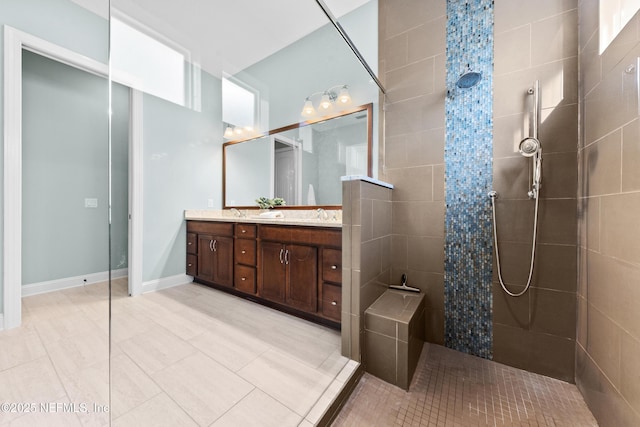 bathroom with vanity and tiled shower