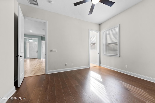 unfurnished bedroom featuring dark wood-type flooring and ceiling fan