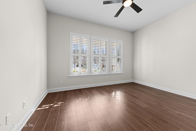 spare room with dark wood-type flooring and ceiling fan