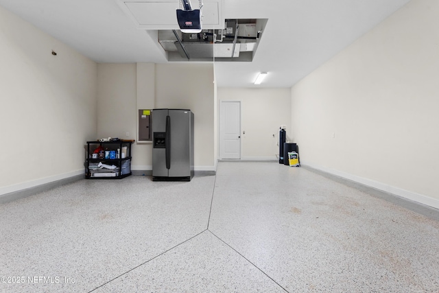 garage featuring stainless steel refrigerator with ice dispenser, a garage door opener, and electric panel