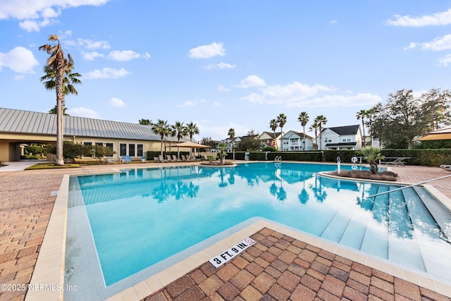 view of swimming pool featuring a patio area