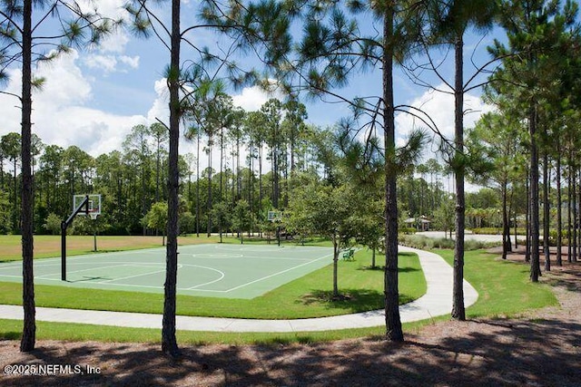 view of basketball court featuring a yard and a wealth of natural light