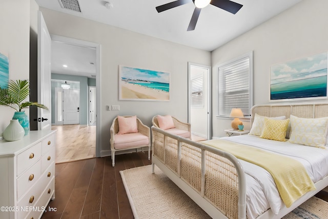 bedroom with dark hardwood / wood-style floors and ceiling fan