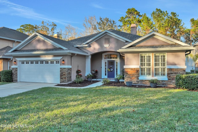 view of front of house featuring a front lawn and a garage