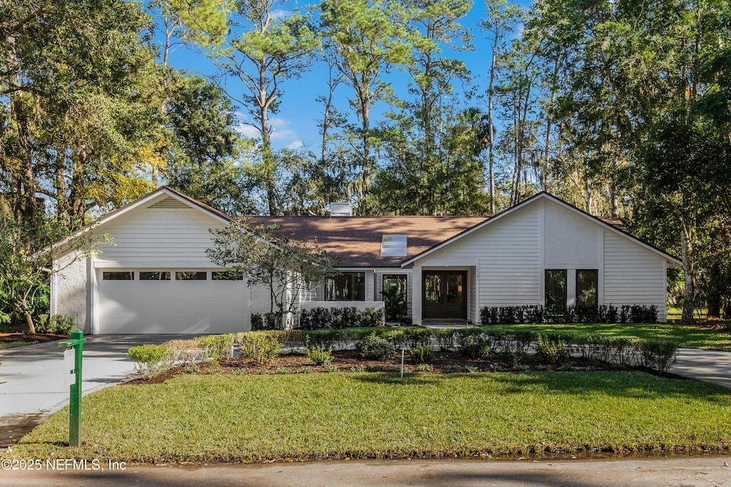 ranch-style home with a front yard and a garage