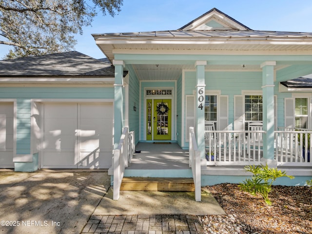 property entrance featuring a porch and a garage