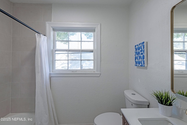 full bathroom with toilet, vanity, and shower / tub combo with curtain